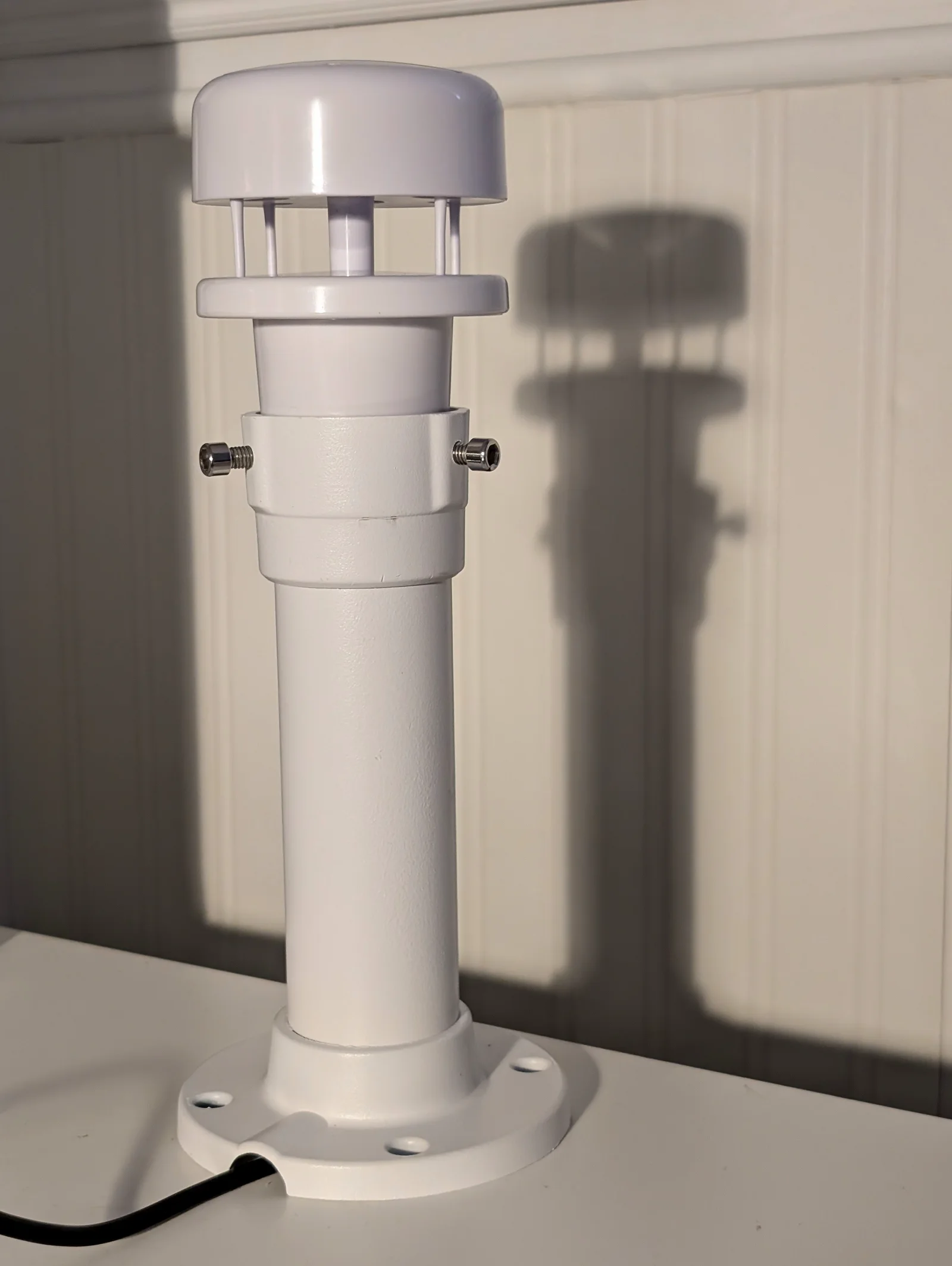White Veinasa CXS02B-N ultrasonic wind sensor standing upright indoors before installation