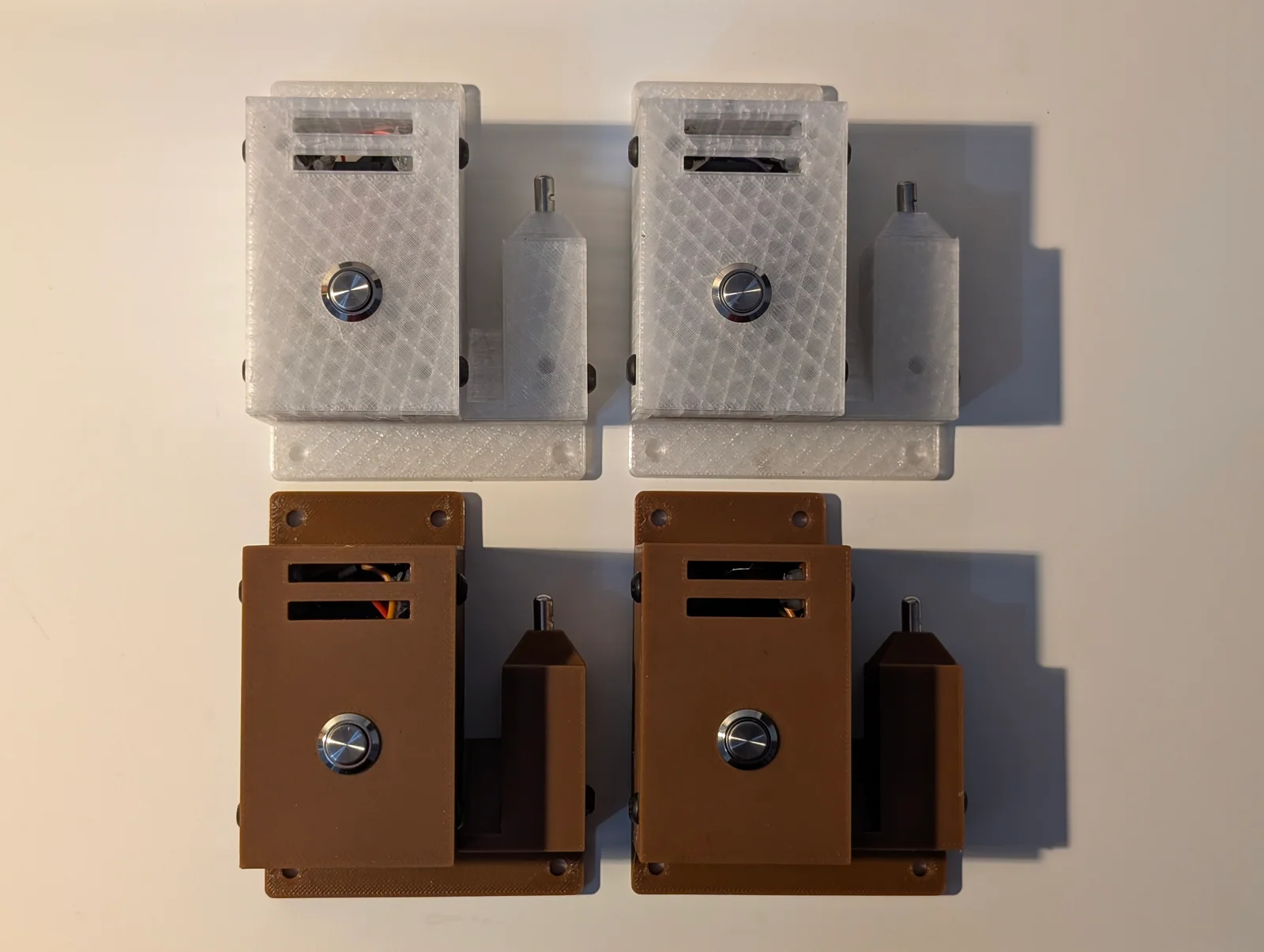 All four completed Wi-Fi sensors: two translucent and two brown enclosures, each with a front setup button and a separate sensor housing