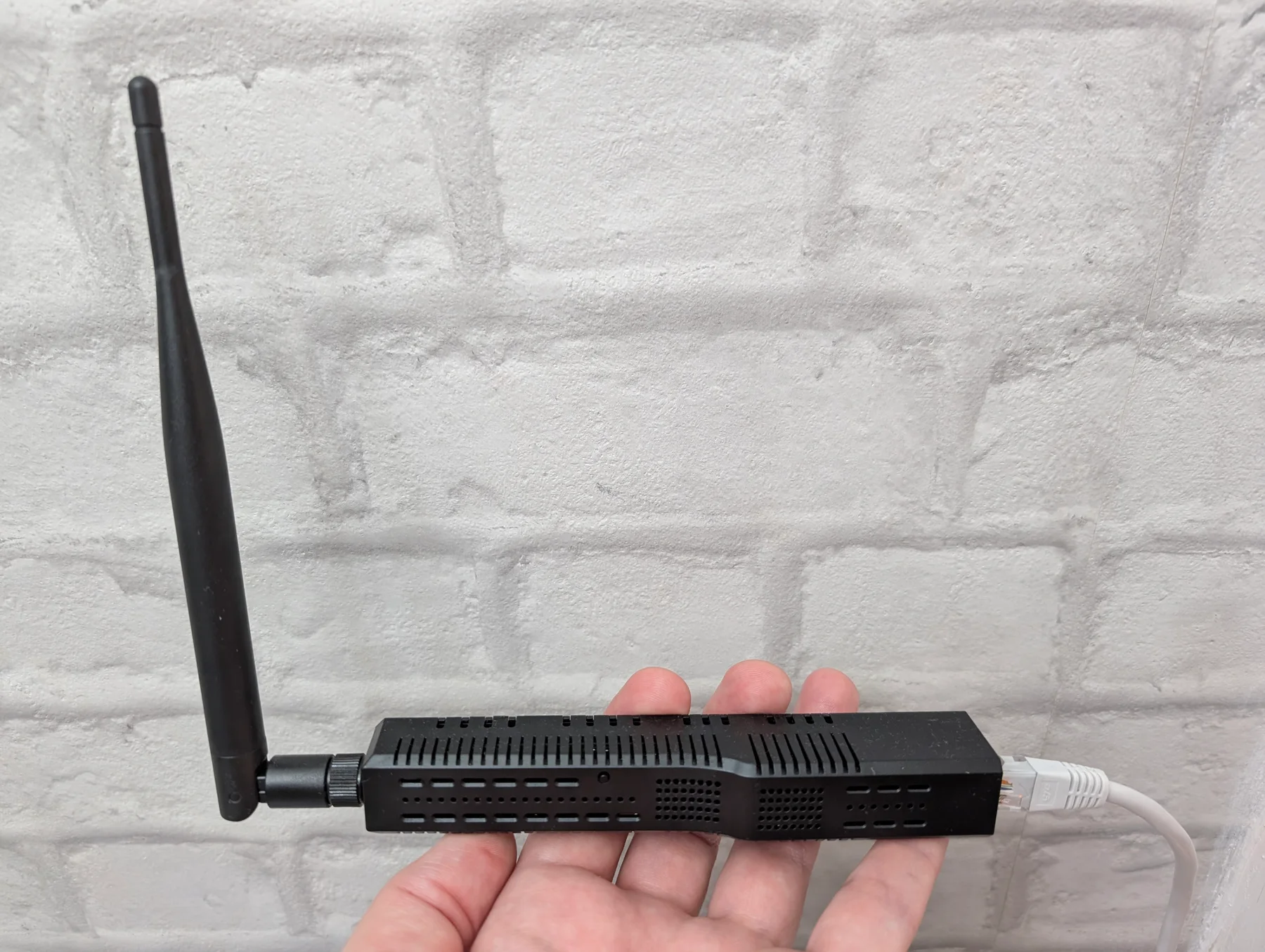 SMLIGHT SLZB-06p7U hub with its external antenna and Ethernet cable connected